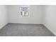 Carpeted bedroom with a window and ample closet space at 312 Castle Dr, Lake Alfred, FL 33850