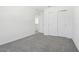 Carpeted bedroom features sliding closet doors and an open doorway at 312 Castle Dr, Lake Alfred, FL 33850