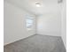 Bright, carpeted bedroom featuring a window for natural light at 312 Castle Dr, Lake Alfred, FL 33850