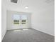 Bedroom features neutral paint, plush carpet, natural light and views at 312 Castle Dr, Lake Alfred, FL 33850
