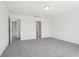 Bedroom features neutral paint and plush carpet at 312 Castle Dr, Lake Alfred, FL 33850