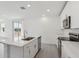 Modern kitchen features quartz countertops and stainless steel appliances at 312 Castle Dr, Lake Alfred, FL 33850