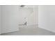 Bright living room with gray tile flooring and a staircase to the second floor at 312 Castle Dr, Lake Alfred, FL 33850