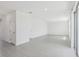 Spacious, bright living room with gray tile flooring and access to the kitchen and sliding glass door at 312 Castle Dr, Lake Alfred, FL 33850