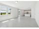 Open living room features modern tile floors, lots of light, and adjoins the kitchen at 312 Castle Dr, Lake Alfred, FL 33850