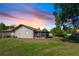 Spacious backyard with green grass, a screened lanai, and a fence, ideal for outdoor activities at 320 Dublin Dr, Lake Mary, FL 32746