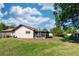 Spacious backyard showcasing the home's exterior and lush green lawn at 320 Dublin Dr, Lake Mary, FL 32746