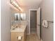 Bright bathroom with ample counter space, large mirror, and neutral tile flooring at 320 Dublin Dr, Lake Mary, FL 32746
