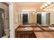 Bright bathroom featuring wood cabinets, spacious countertop, and large mirror with vanity lighting at 320 Dublin Dr, Lake Mary, FL 32746