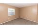 Cozy bedroom with carpet flooring and a window offering natural light at 320 Dublin Dr, Lake Mary, FL 32746