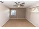 Spacious bedroom featuring neutral walls, carpet flooring, and a ceiling fan with natural light from two windows at 320 Dublin Dr, Lake Mary, FL 32746