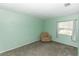 Cozy bedroom with carpet flooring, natural light and a comfortable chair at 320 Dublin Dr, Lake Mary, FL 32746