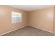 Bedroom with neutral walls and carpet floors, illuminated by a window at 320 Dublin Dr, Lake Mary, FL 32746