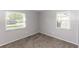 Bedroom showcasing carpet flooring and two windows for ample natural light at 320 Dublin Dr, Lake Mary, FL 32746