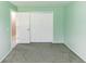 The bedroom has green walls and carpeting with a big closet at 320 Dublin Dr, Lake Mary, FL 32746