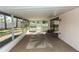 Enclosed sunroom with lots of light and a palm tree rug overlooking the backyard at 320 Dublin Dr, Lake Mary, FL 32746