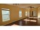 A living room featuring gleaming hardwood floors, neutral-colored walls, and multiple windows for ample sunlight at 3734 Hampton Hills Dr, Lakeland, FL 33810