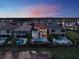 Aerial view showcasing the property, pool, and well-manicured landscaping in a serene neighborhood at 411 Muirfield Loop, Reunion, FL 34747