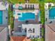 Aerial view of a backyard featuring a swimming pool, hot tub, patio, outdoor furniture and a spiral staircase at 411 Muirfield Loop, Reunion, FL 34747