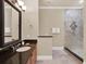 An elegant bathroom featuring granite countertops, vanity, and a glass shower at 411 Muirfield Loop, Reunion, FL 34747