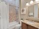 An inviting bathroom featuring a shower-tub combo and granite countertops at 411 Muirfield Loop, Reunion, FL 34747