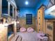 A whimsical bedroom with a castle-themed bunk bed and mural painted walls at 411 Muirfield Loop, Reunion, FL 34747