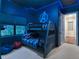 An Avengers themed bedroom with a bunk bed and illuminated blue lighting at 411 Muirfield Loop, Reunion, FL 34747