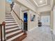 Spacious foyer features tile floors, a staircase with wood and iron railings, and double front doors at 411 Muirfield Loop, Reunion, FL 34747