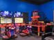 Game room with multiple arcade games and a basketball hoop, perfect for entertainment at 411 Muirfield Loop, Reunion, FL 34747