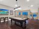 An inviting game room featuring a billiards table and a flatscreen TV for entertainment at 411 Muirfield Loop, Reunion, FL 34747