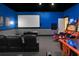 Entertainment room with a movie screen, gaming consoles, and arcade machines for fun gatherings at 411 Muirfield Loop, Reunion, FL 34747