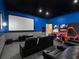 Recreational game room with a large movie screen, seating, and arcade games for endless entertainment at 411 Muirfield Loop, Reunion, FL 34747