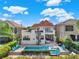 View of a backyard featuring a swimming pool, hot tub, spiral staircase, patio, and outdoor furniture at 411 Muirfield Loop, Reunion, FL 34747