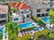 Aerial view of a backyard featuring a swimming pool, hot tub, patio, outdoor furniture and a spiral staircase at 411 Muirfield Loop, Reunion, FL 34747