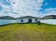 Spacious backyard features a large grassy area, privacy fence, and potential for outdoor enjoyment at 417 Patricia Alford Dr, Haines City, FL 33844