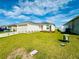 Well maintained home with a green lawn, solar panels and desert landscaping beneath the front window at 417 Patricia Alford Dr, Haines City, FL 33844