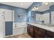 Beautiful blue bathroom features a soaking tub, glass shower, and double sink vanity at 432 Treasure Ln, Sanford, FL 32771