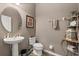 Cozy powder room featuring a pedestal sink, decorative shelves, and neutral wall paint at 432 Treasure Ln, Sanford, FL 32771