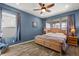 Spacious bedroom with hardwood floors, ceiling fan and natural wood king bed at 432 Treasure Ln, Sanford, FL 32771