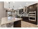 Stylish kitchen with granite counters, dark wood cabinetry, and a stainless steel range hood at 432 Treasure Ln, Sanford, FL 32771