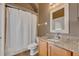 Clean bathroom featuring a single vanity with granite countertops, a mirror, and a shower with a patterned curtain at 4907 Culdesac Ct, St Cloud, FL 34772