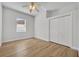 Bright bedroom featuring wood-look tile floors, a window with blinds, and a closet at 4907 Culdesac Ct, St Cloud, FL 34772