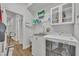 Bright laundry room with white washer and dryer, overhead cabinets, and access to the hallway at 4907 Culdesac Ct, St Cloud, FL 34772