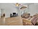 Living room with ceiling fan, wood-look flooring, and sliding glass doors to pool at 4907 Culdesac Ct, St Cloud, FL 34772