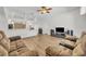 Living room with ceiling fan, wood-look flooring, and furniture at 4907 Culdesac Ct, St Cloud, FL 34772