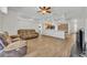 Living room with ceiling fan, wood-look flooring, and furniture at 4907 Culdesac Ct, St Cloud, FL 34772