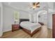 Main bedroom featuring wood-look flooring, ceiling fan, and large windows at 4907 Culdesac Ct, St Cloud, FL 34772