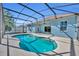 Screened-in kidney shaped pool offers a refreshing oasis, perfect for relaxation and entertaining at 4907 Culdesac Ct, St Cloud, FL 34772