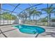 Inviting screened-in pool area with a clear blue pool, white picket fence, and lush palm trees at 4907 Culdesac Ct, St Cloud, FL 34772