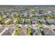 Panoramic aerial view of a residential neighborhood with well-maintained homes, green lawns, and mature trees at 501 Burma St, Kissimmee, FL 34747